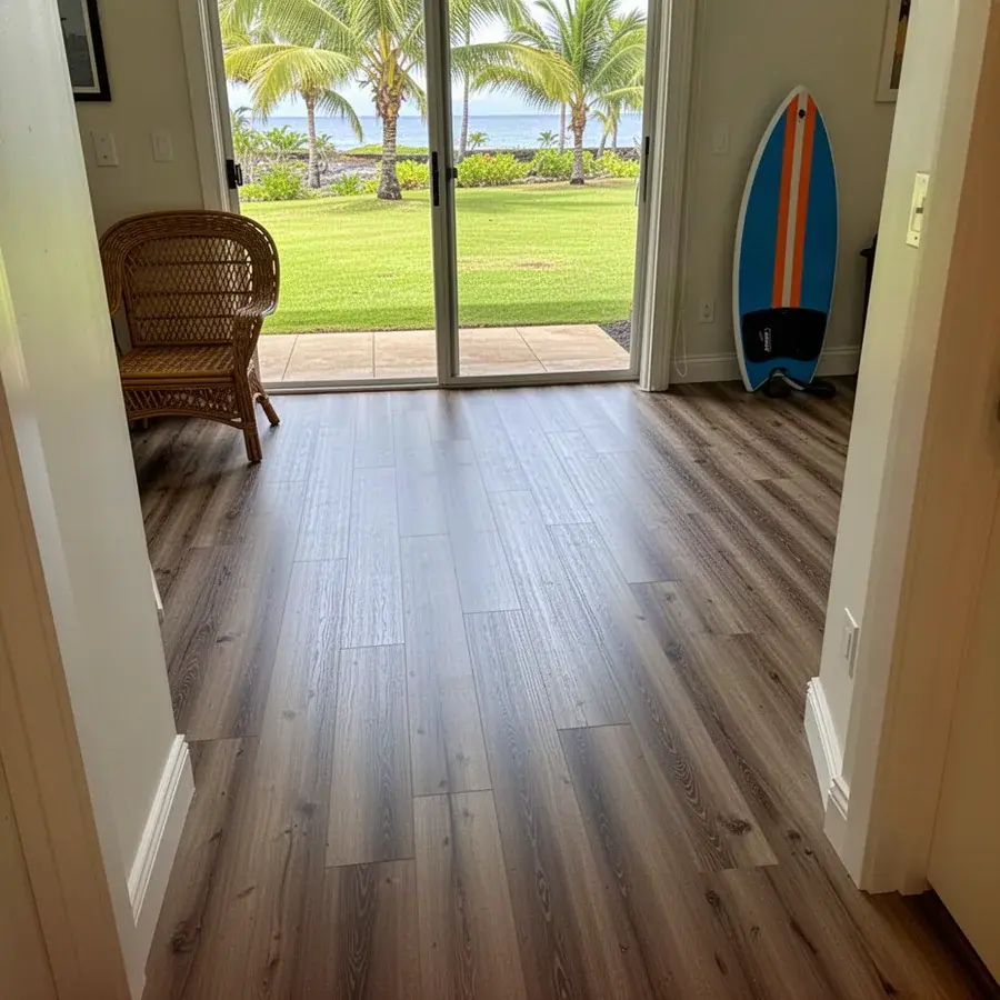 Vinyl plank laid flat right up to the lanai door Glue-down vinyl plank floor in ground-floor Kihei condo